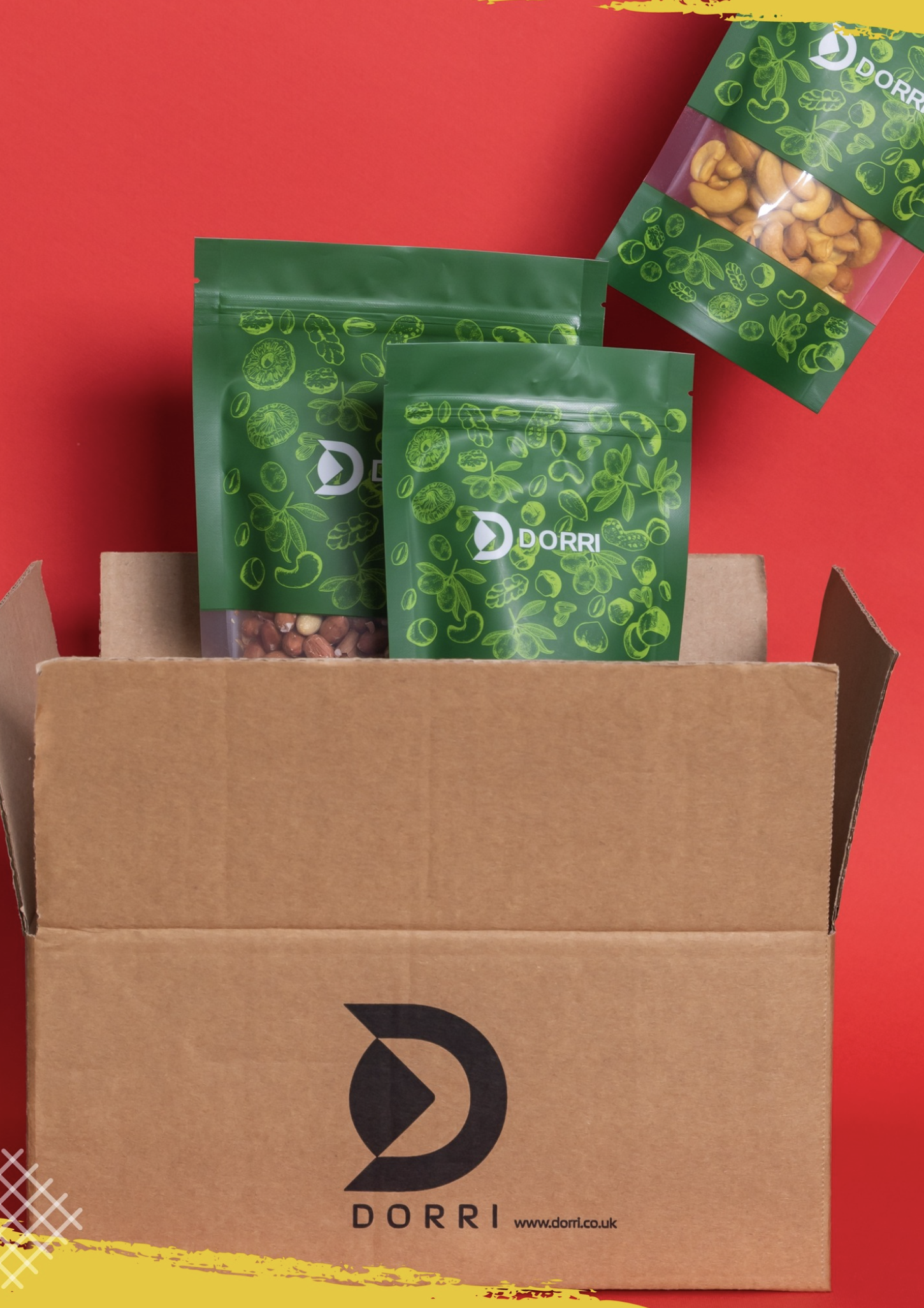 Dorri kraft shipping box on a red background with the black D logo and www.dorri.co.uk, green botanical pouches emerging from the carton